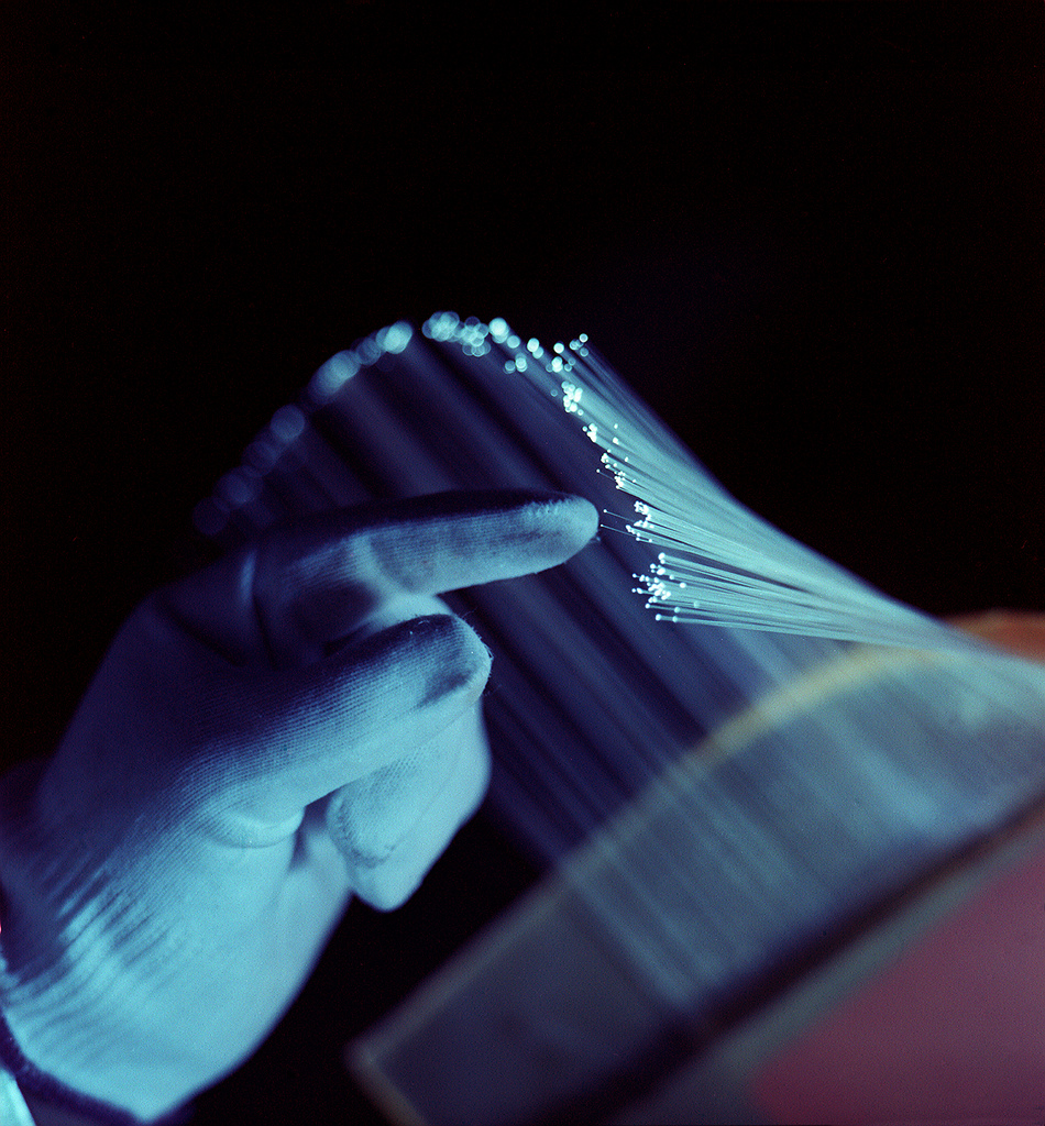 Scintillating glass optical fibres glowing under ultraviolet illumination